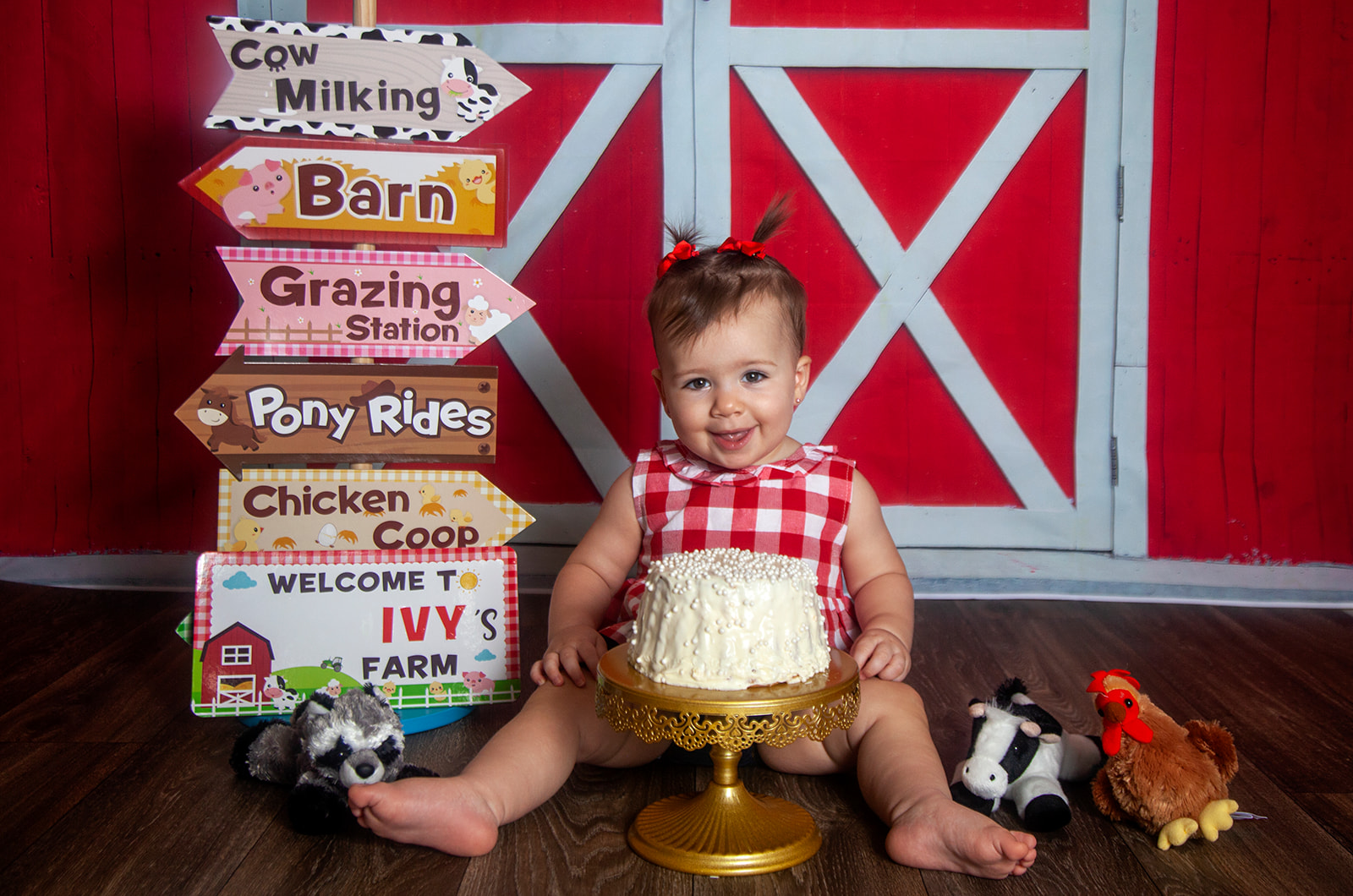 Baby sitting with cake in a farm setting